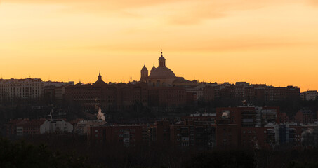 Fototapeta premium view of the city of madrid at dawn with the rays of the sun, cathedral of madrid