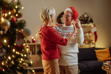 Grandparents dancing and smiling at home