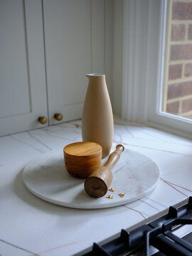 Jar and pot on a plate near the window