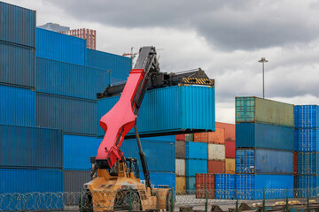 Reach stacker moves intermodal container to railroad platform.