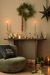 Aesthetic composition of christmas living room interior with green armchair, wooden bench, pillows, gifts, candle with candlestick, star and personala ccessories. Home decor. Template.