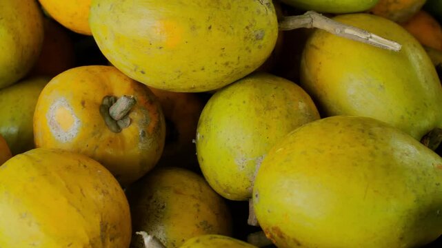 Closeup of Ripe Canistel (Pouteria campechiana) Piled High at a Tropical Fruit Stall, Showcasing Its Soft and Sweet Texture
