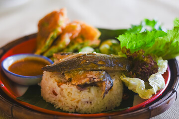 Shrimp paste sauce with crispy fried fish and sweet pork in a plate