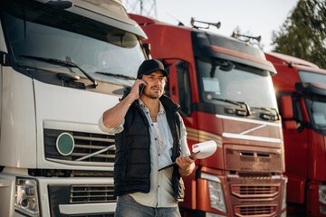 Business things, with notepad. Truck driver is near the transport outdoors