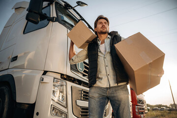 Shipping conception, with boxes. Truck driver is near the transport outdoors