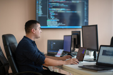 A programmer diligently testing smartphone applications while sitting in their office.