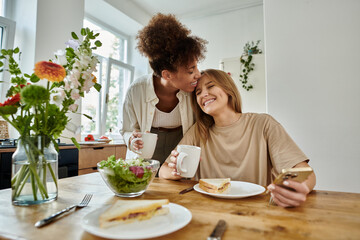 A loving couple shares a delightful moment over lunch, smiling and savoring their time.