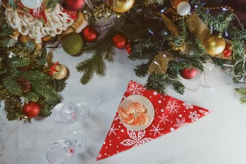 New Year timelapse. against the background of Christmas decor, a tangerine, two champagne glasses and sparklers appear. The concept of a happy new year and Merry Christmas. - Powered by Adobe