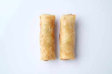 Pair of spring rolls on blank white plate