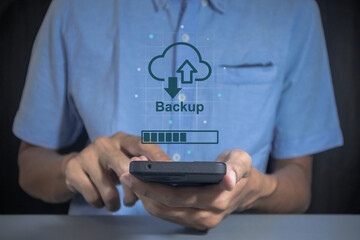 Phone data backup and cloud data storage concept. Man using a smartphone to upload data to cloud...