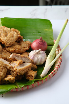 Deep fried Cha Lua slices served on a banana leaf in a woven basket.