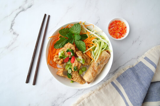 Bun Cha Gio bowl topped with fried spring roll and Cha Lua.