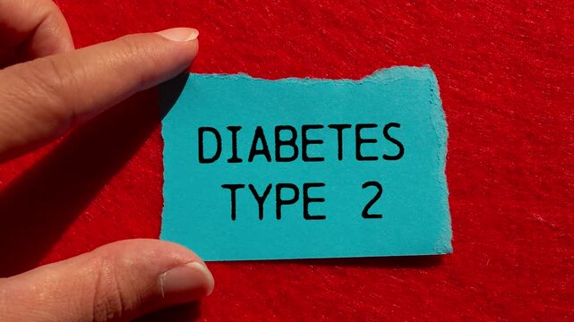Diabetes type 2 message writing on ripped blue torn paper piece on red background. Conceptual diabetes type 2 symbol.