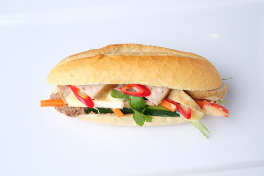 Meatloaf Bahn Mi filled with fresh herbs and vegetables.