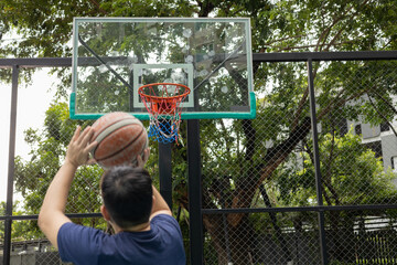Man Stretching on Basketball Court Outdoors