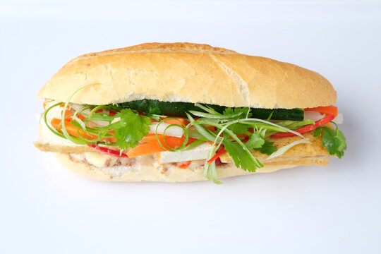 Meatloaf Bahn Mi filled with fresh herbs and vegetables.