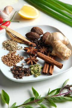 Spices and herbs on white table