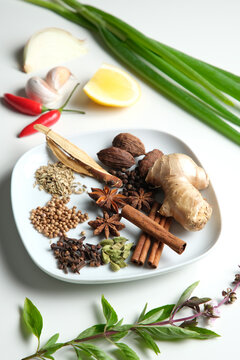 Spices and herbs on white table