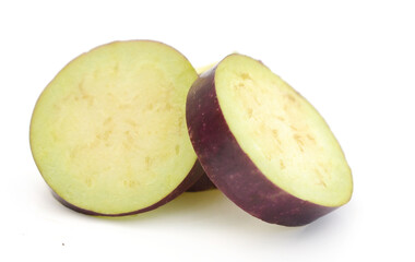 Aubergine, Solanum melongena, egg plant, single ripe fruit and halved fruit next to it - stock photo
