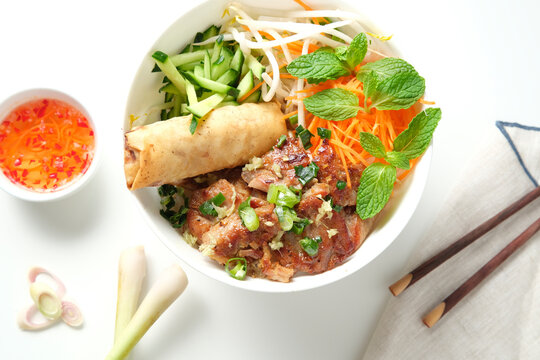 Bun Cha Gio bowl with meat slices topped with fried spring roll.