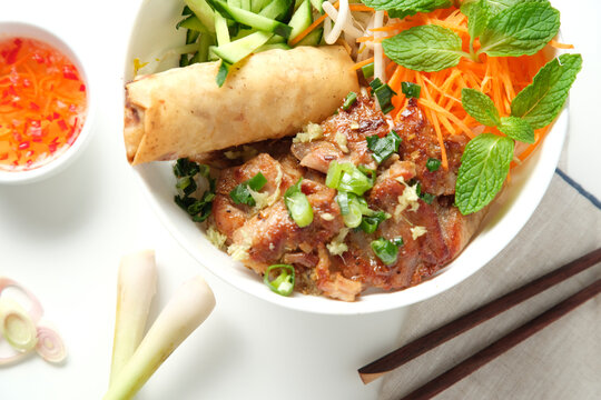 Bun Cha Gio bowl with meat slices topped with fried spring roll.