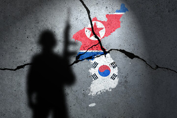 Flags of North Korea and South Korean painted on the concrete wall with soldier shadow