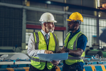 Foreman or worker work at factory site check up machine or products in site.