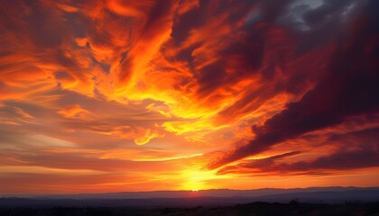 Dramatic orange and red sunset sky with dark clouds, inspirational evening