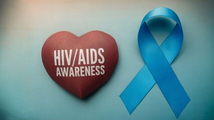 Red heart with the inscription "HIV/AIDS awareness" and blue ribbon on a blue background. Concept for World AIDS Day. Health and healthcare concept. Background for banner, poster, flyer, card.