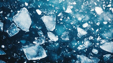 Shattered ice fragments on a river scattered among snow in winter with an abstract blue backdrop
