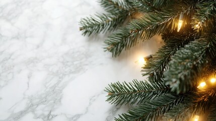 Obraz premium Christmas tree branches with bokeh blurred fairy lights set against a marble background