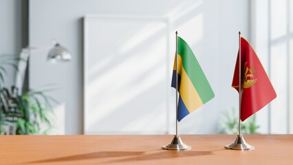FLAGS OF GABON AND MONTENEGRO ON TABLE