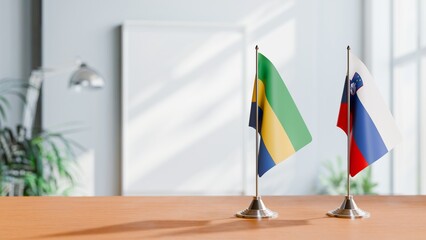 FLAGS OF GABON AND SLOVENIA ON TABLE
