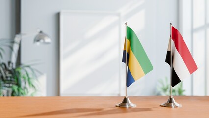 FLAGS OF GABON AND YEMEN ON TABLE