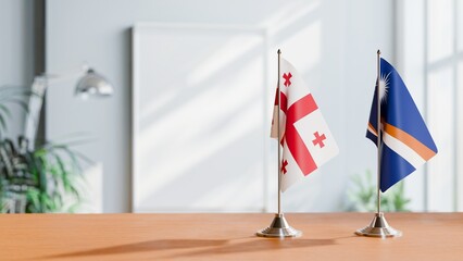 FLAGS OF GEORGIA AND MARSHALL ISLANDS ON TABLE