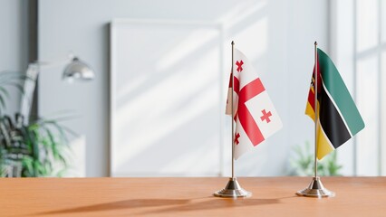 FLAGS OF GEORGIA AND MOZAMBIQUE ON TABLE