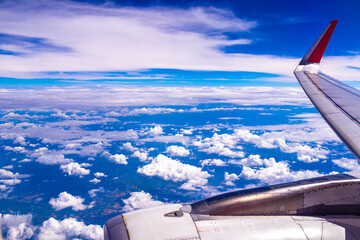 Flying in airplane view of blue sky and clouds Thailand.