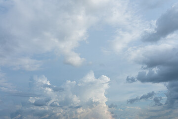 Fluffy white clouds drift across a vast blue sky