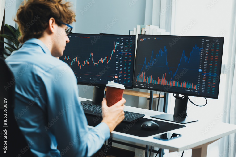 Aufkleber working young business trader focusing on market stock graph data in two screens, holding coffee cup