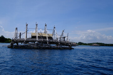 floating cages in the open sea. fish farming in the middle of the sea.