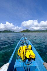 a yellow life jacket at the end of a blue boat. lifejacket is a means of safety in water...