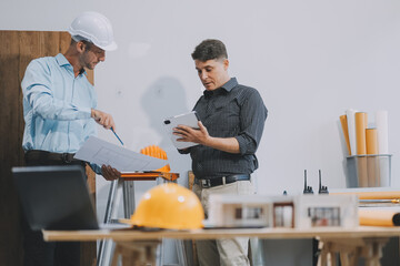 Team Engineers with draft plan of building on constructing site. Engineer work on site. engineer...