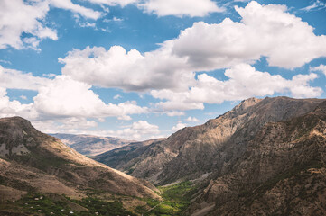 Fototapeta premium Majestic mountains of Armenia under a blue sky filled with clouds