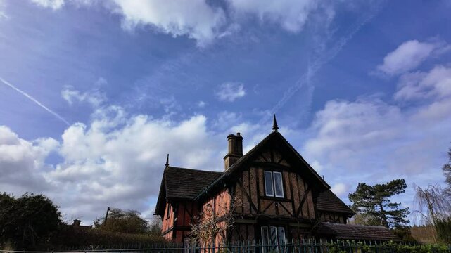 Timelapse of cloudscape above traditional English cottage,Tudor Lodge, Edensor