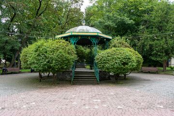Gazebo on the street. Green trees rest zone in park Truskavets