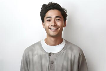 Fototapeta premium Man with a smile on his face is wearing a gray shirt. He is posing for a picture