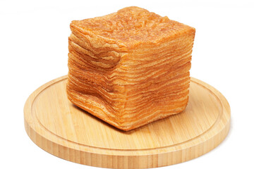 Korean tissue bread—a tall stack of ultra-thin, square bread layers with a buttery croissant-like...