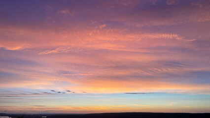 scarlet sunset in cloudy sky