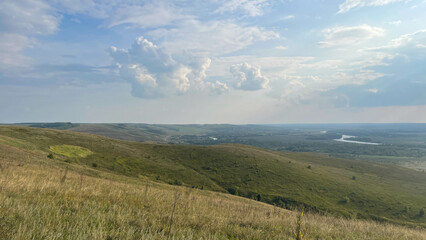Obraz premium views of green hills on a steep river bank