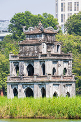 Obraz premium Hanoi, Vietnam, 11-06-2024: view of the Turtle Tower (Thap Rua), a small tower built in 1886 in the middle of Sword Lake (Hoan Kiem Lake), dedicated to the hero Le Loi, one of the symbol of the city